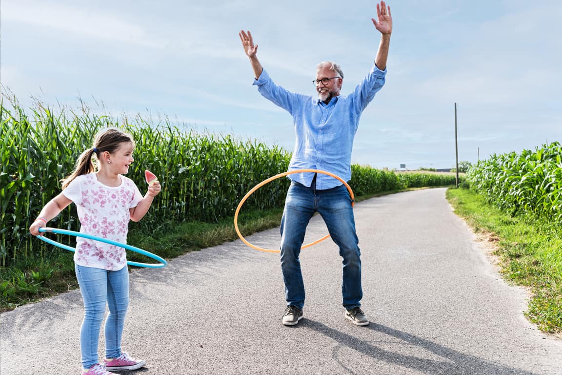 Family playing hula hoop