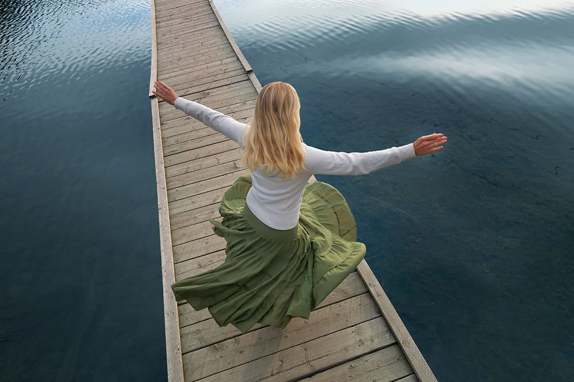 Woman dancing on the bridge.