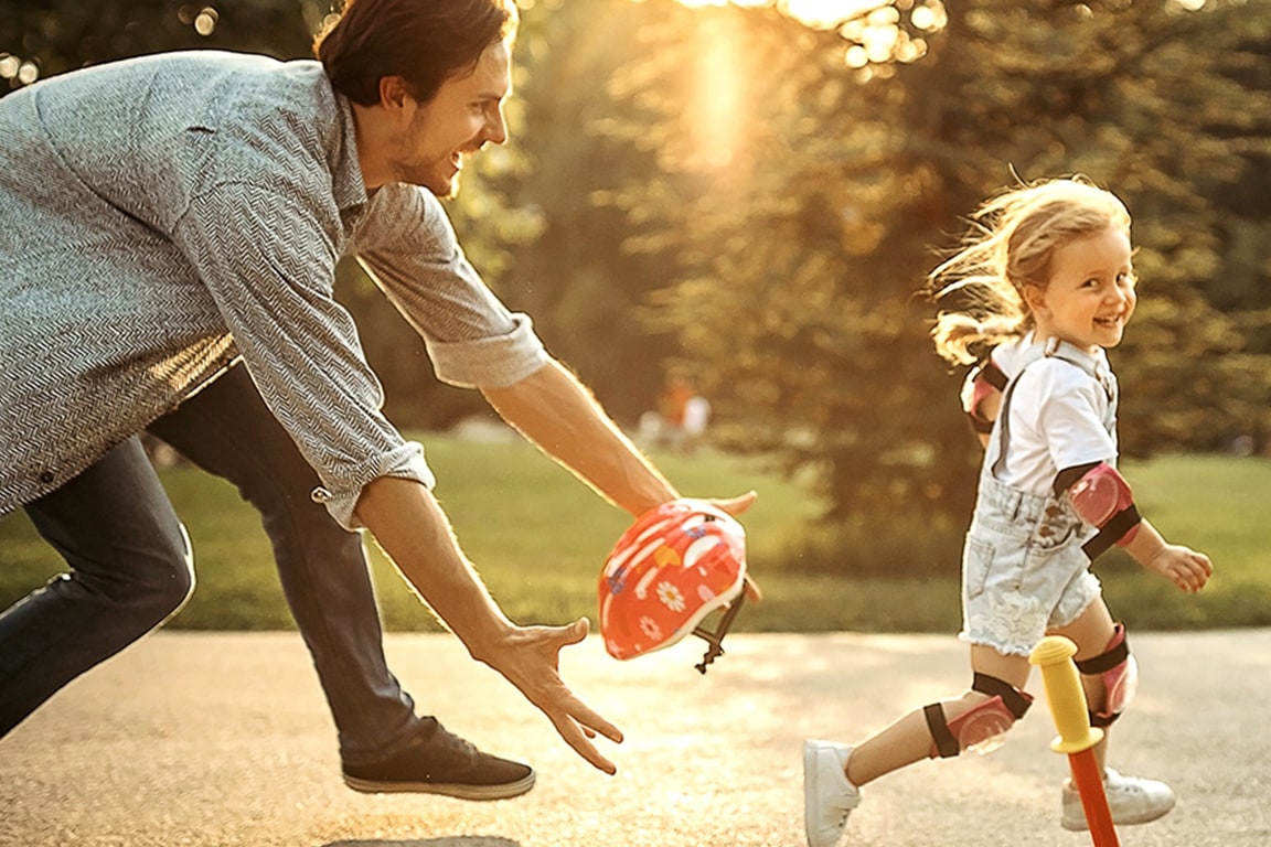 father and daughter playing outside