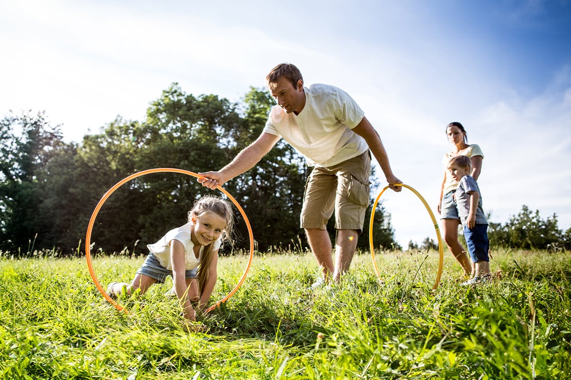 Family of four playing in a park