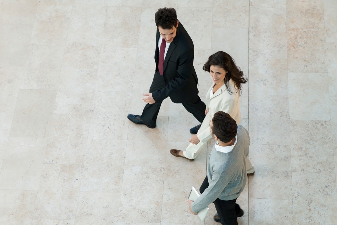 group of 3 business people walking together