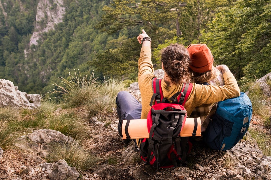 couple enjoying the beautiful landscape of mountains