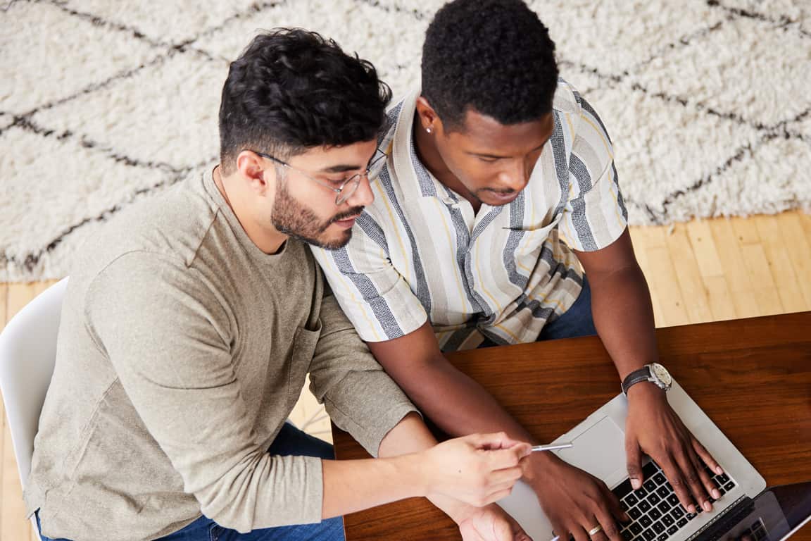 two male working on a laptop