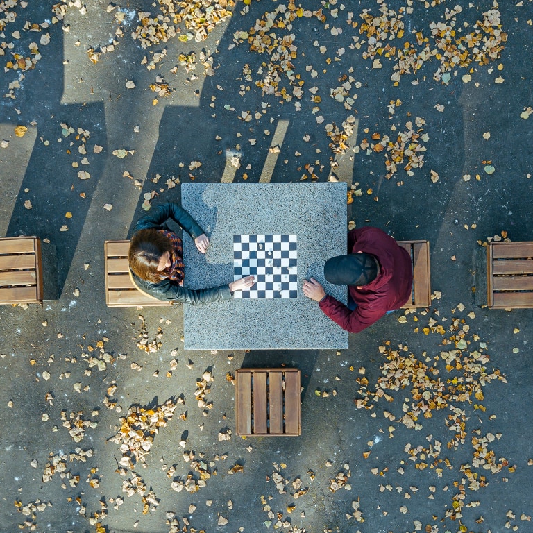 aerial view of couple playing checkers in park