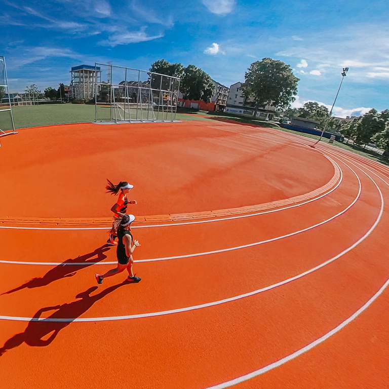 women running on outdoor track