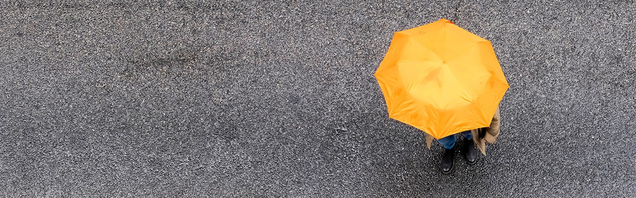 person under yellow umbrella