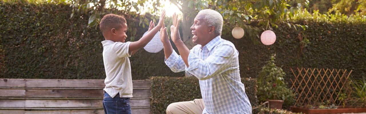 child high-fiving grandfather