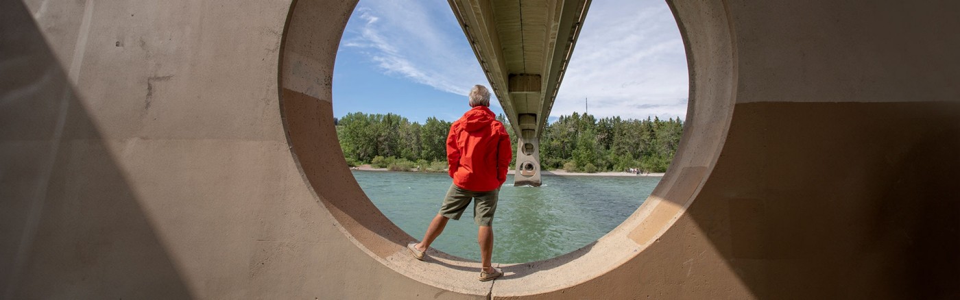Man looking at the view while under the bridge