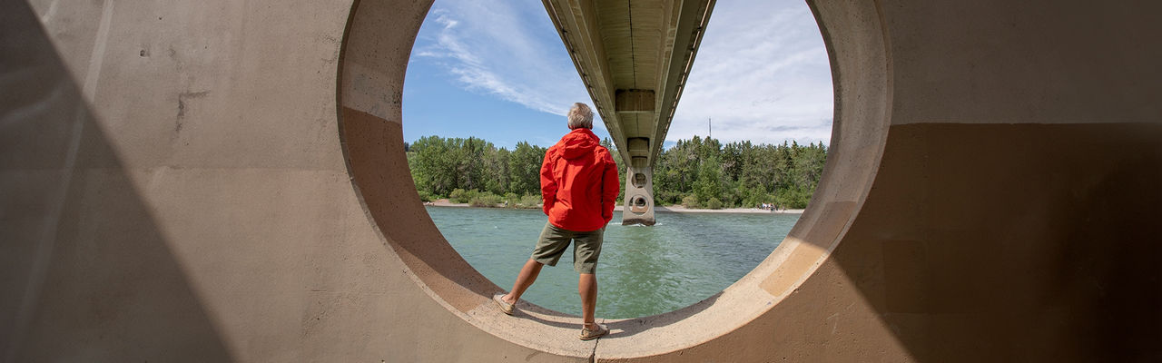 Man looking at the view while under the bridge