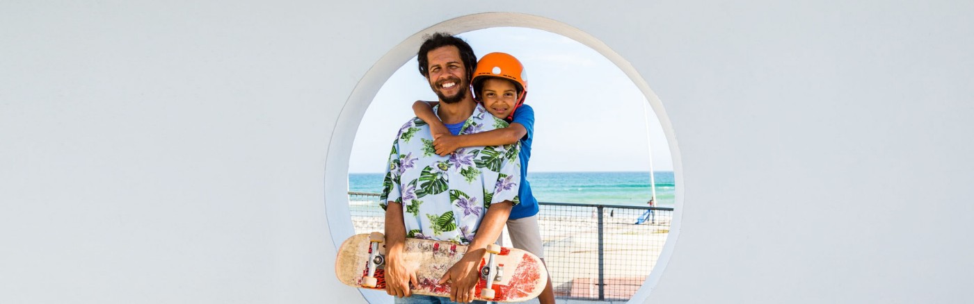 father and son with skateboard