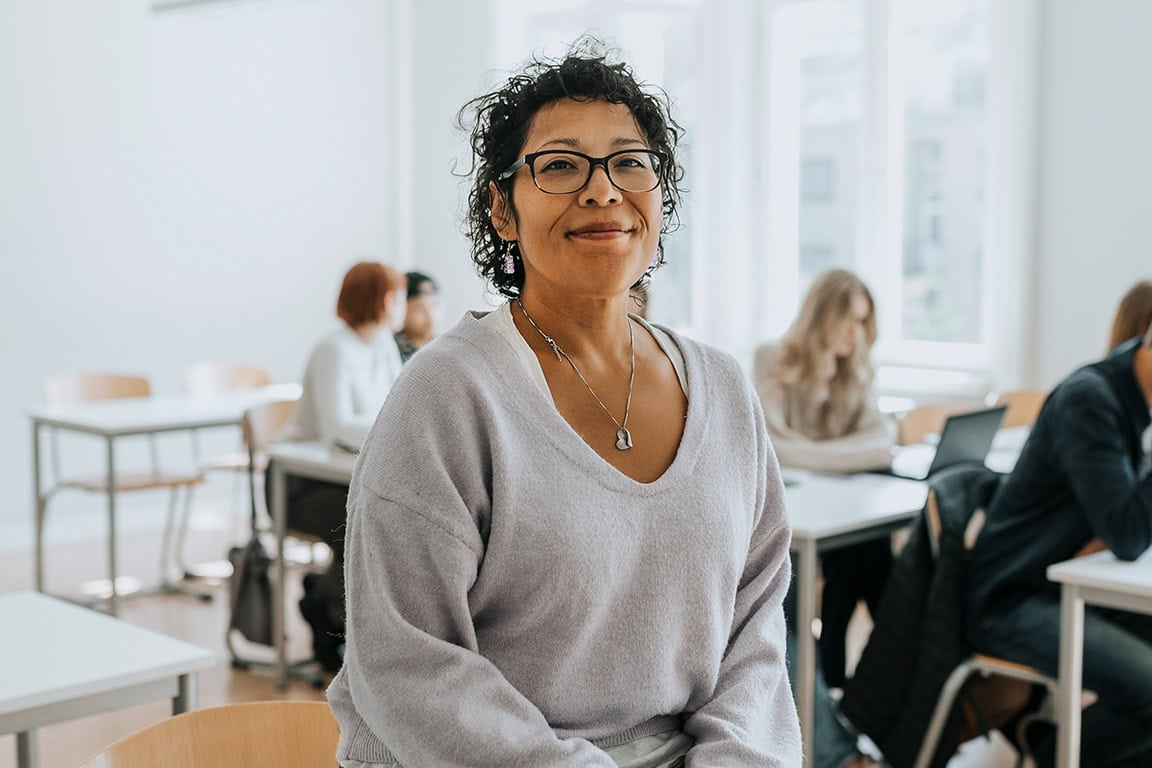 Happy teacher sitting on a chair