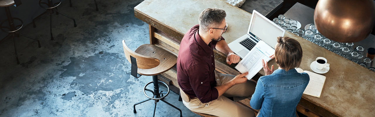 Man and woman discussing a report