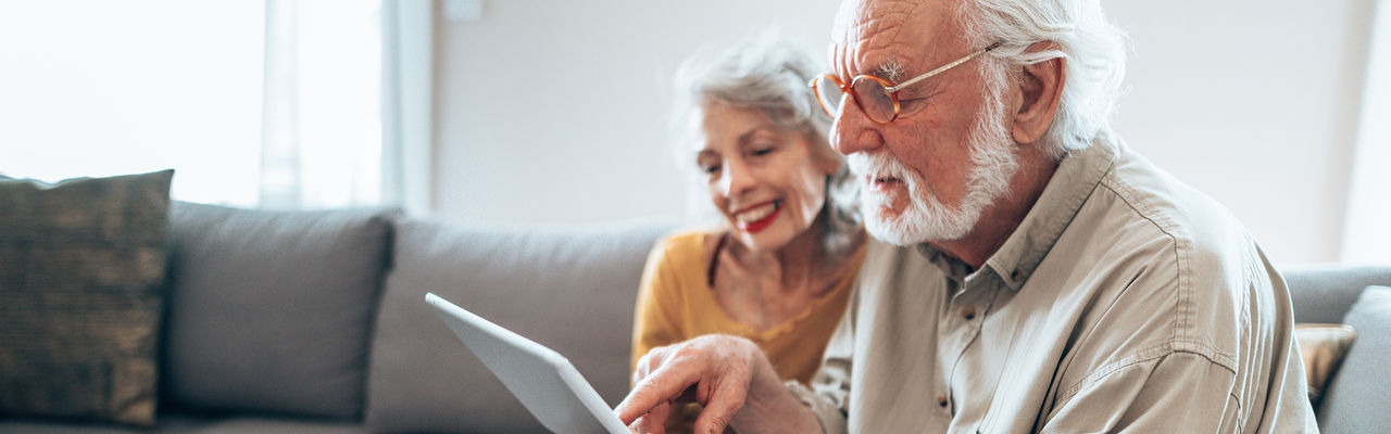 Elderly couple sitting together on a couch