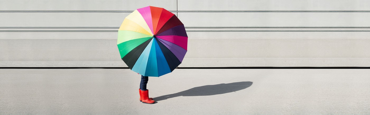 a person holding a colorful umbrella