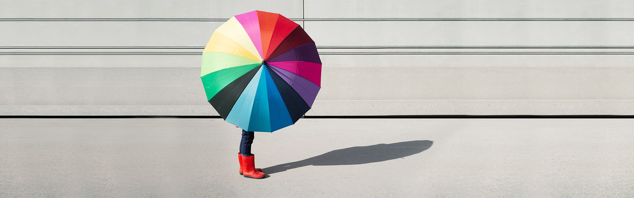a person holding a colorful umbrella