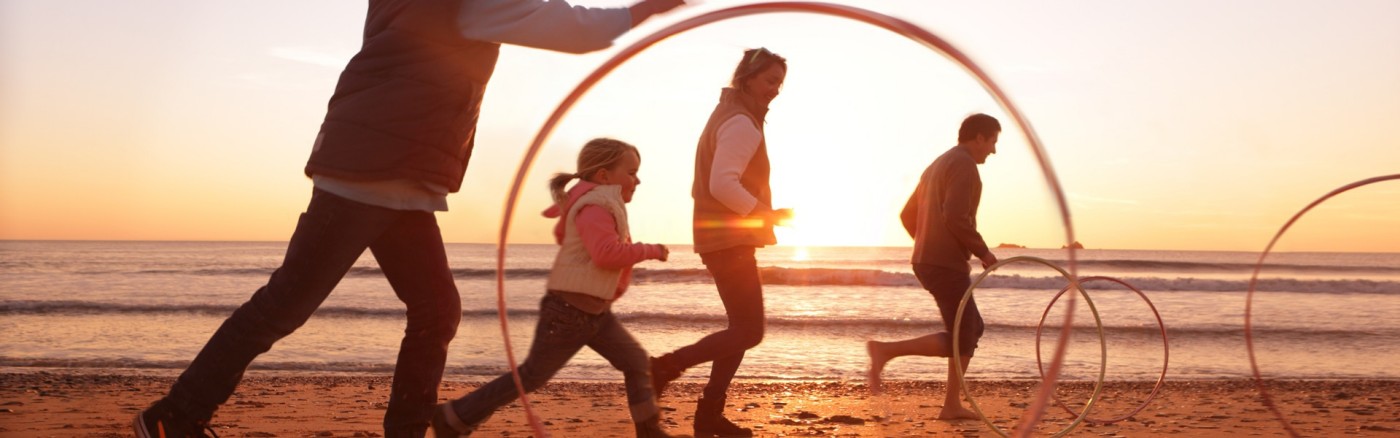 family playing on beach