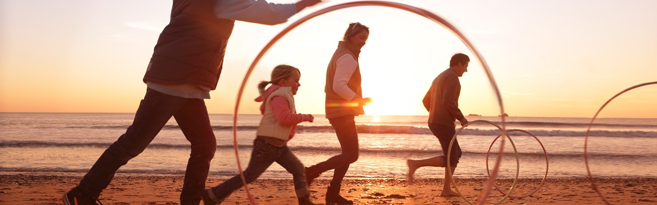 family playing on beach