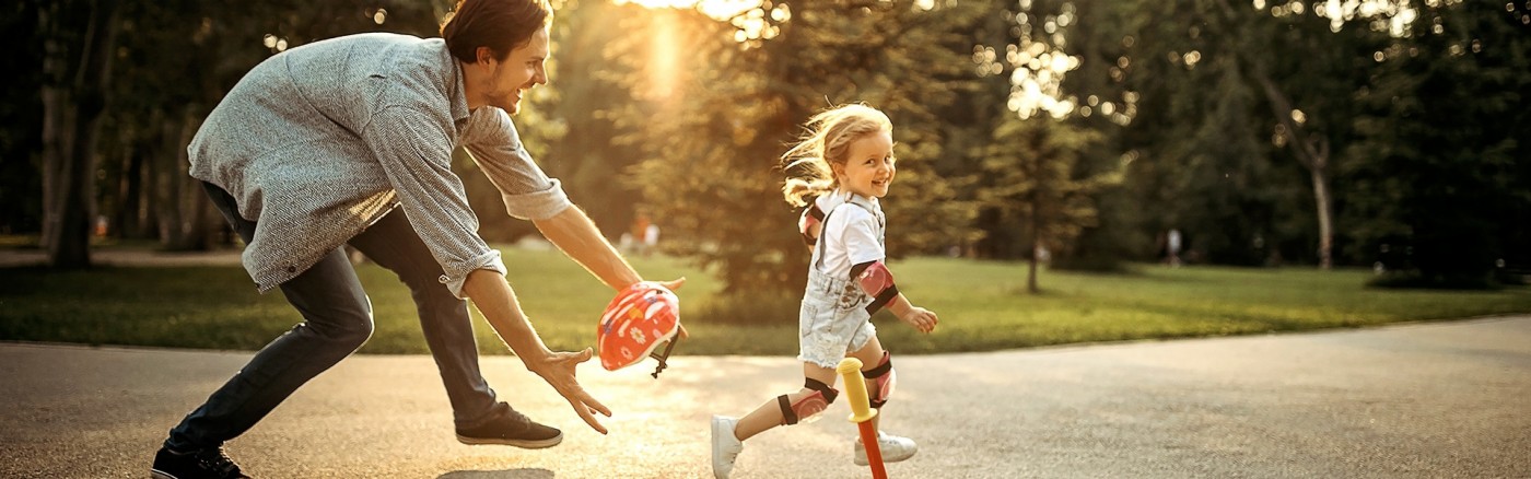 father and daughter playing outside
