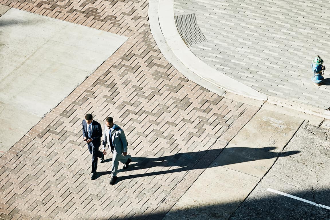 businessman walking on the side walk