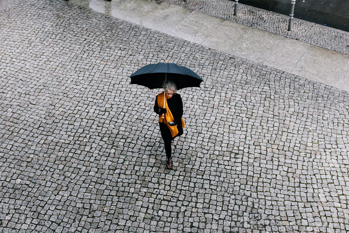 Woman walking on the street with an umbrella