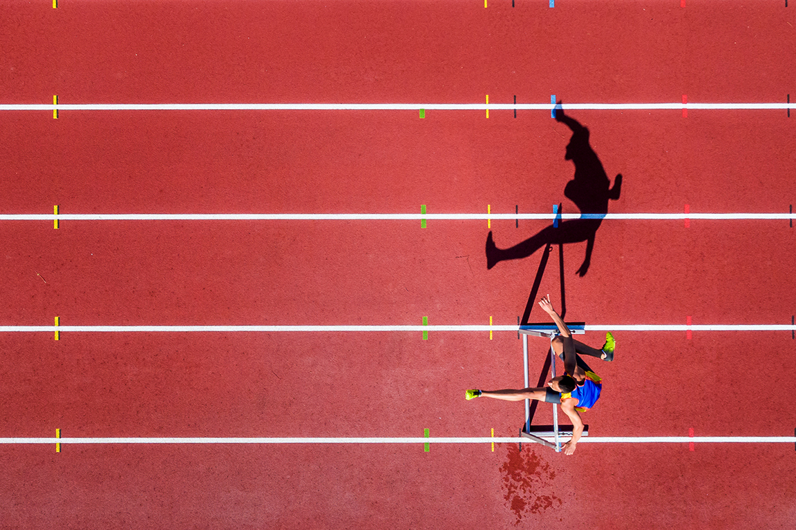 man running hurdles
