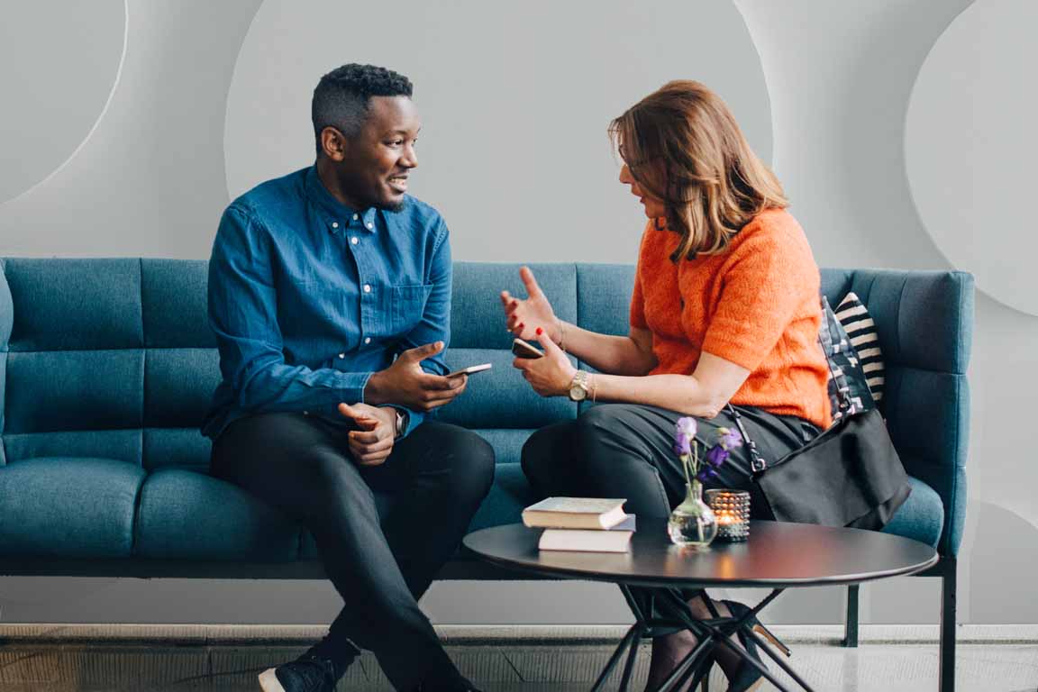couple sitting on a couch talking