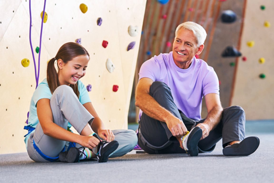Father and daughter rock climbing