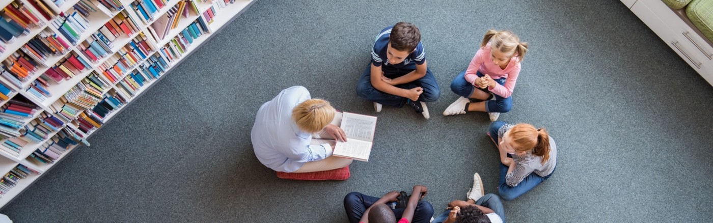 Teacher with students seating in a classroom