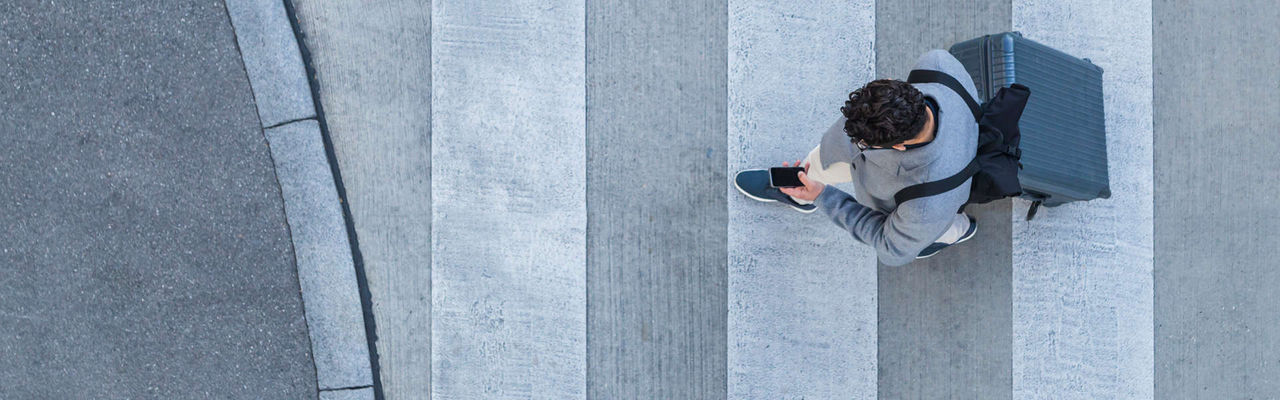 Men walking while looking at iPhone