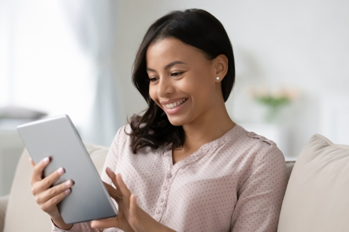 Happy woman looking at an iPad