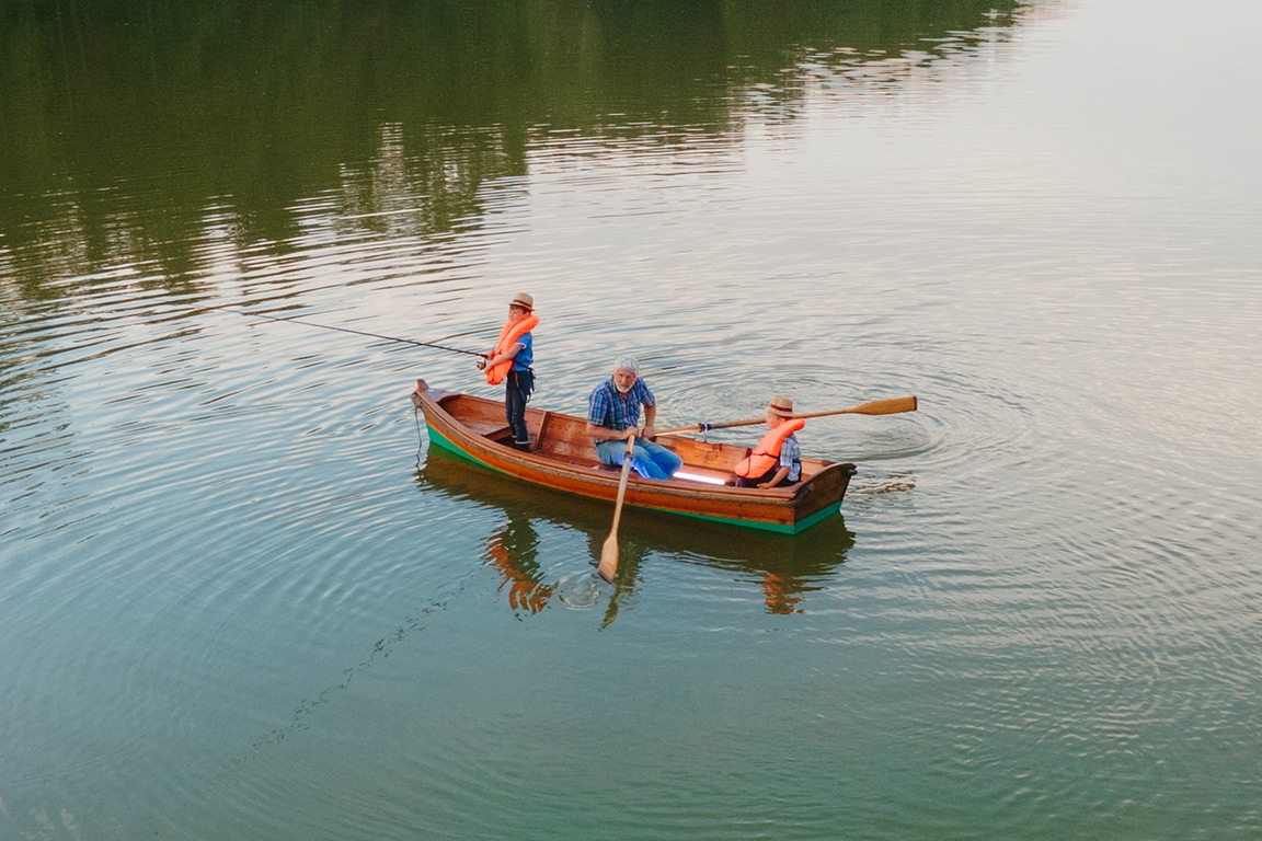 family of three in a small boat