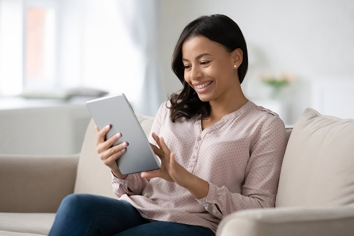 Happy woman looking at her iPad