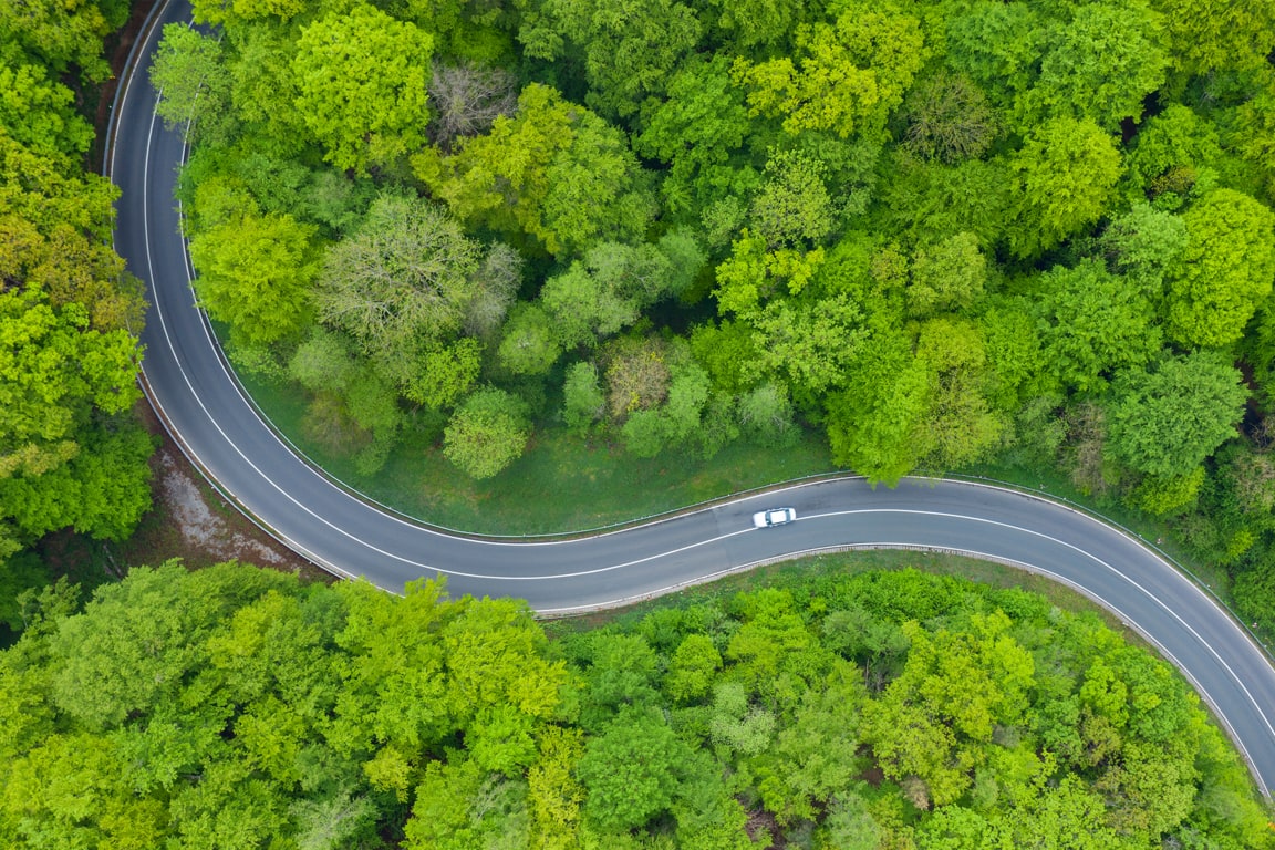 aerial view of car driving on a curvy road