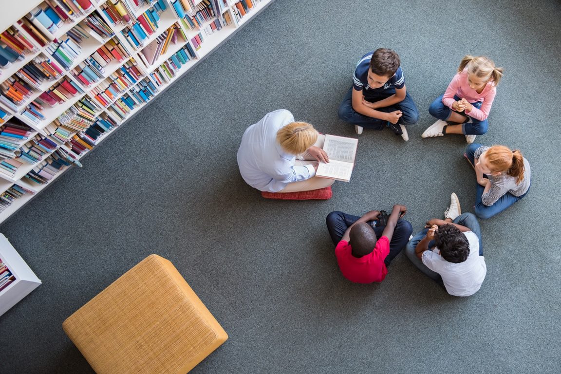 teacher reading to class at circle time