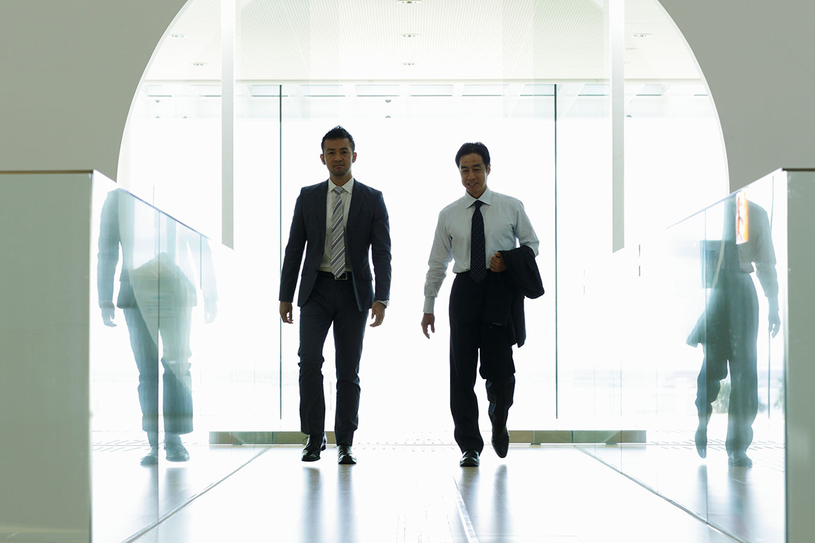 Two corporate men walking