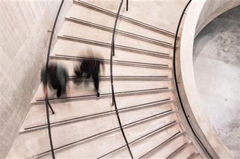 Two people walking down the stairs