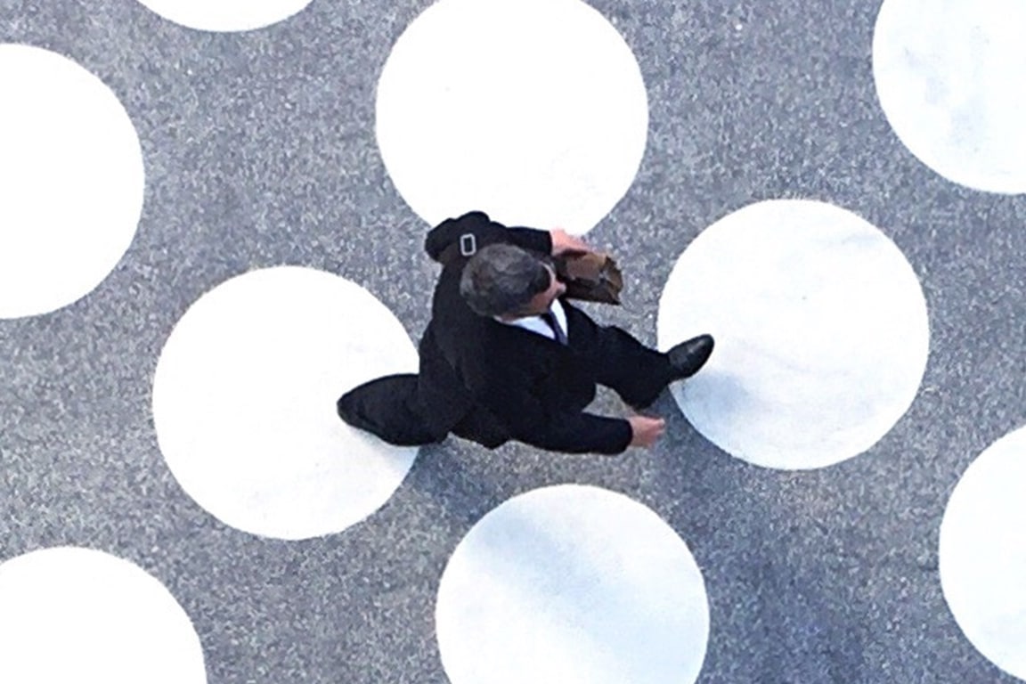 Businessman walking on spotted floor