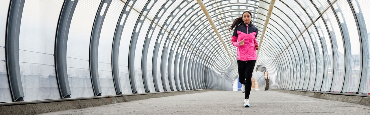 woman running through a tunnel