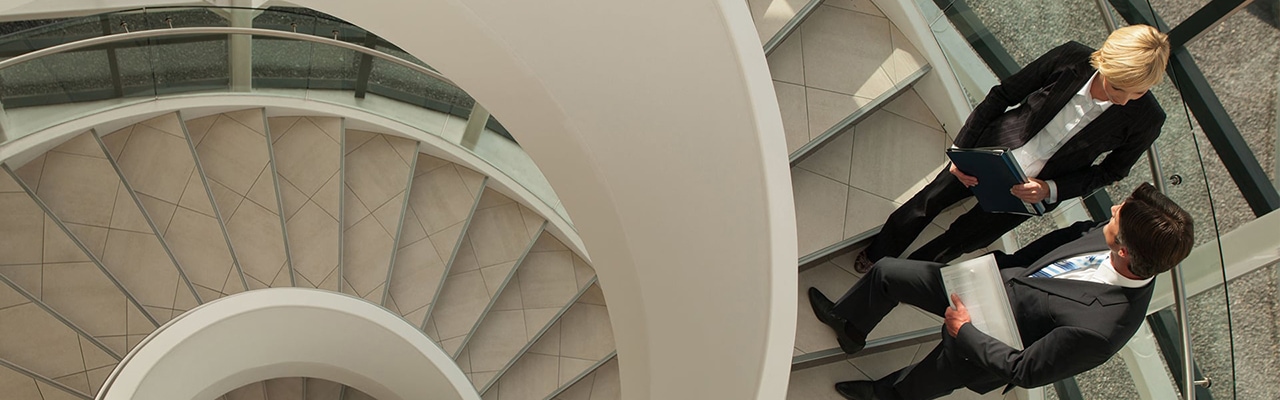 business professionals talking on staircase