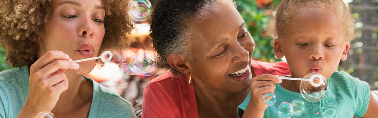 family blowing bubbles