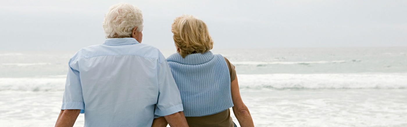 mature couple sitting on the beach