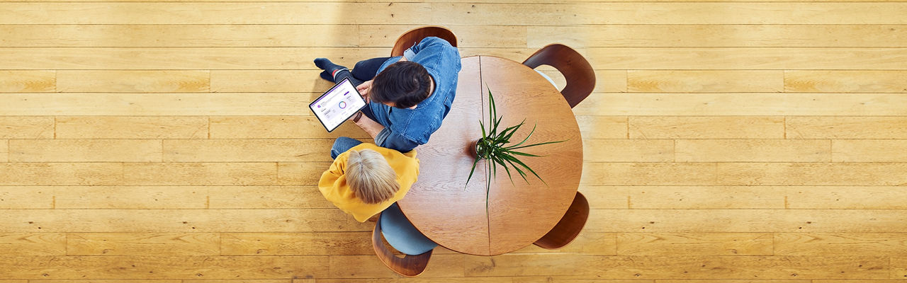 couple standing while looking at iPad