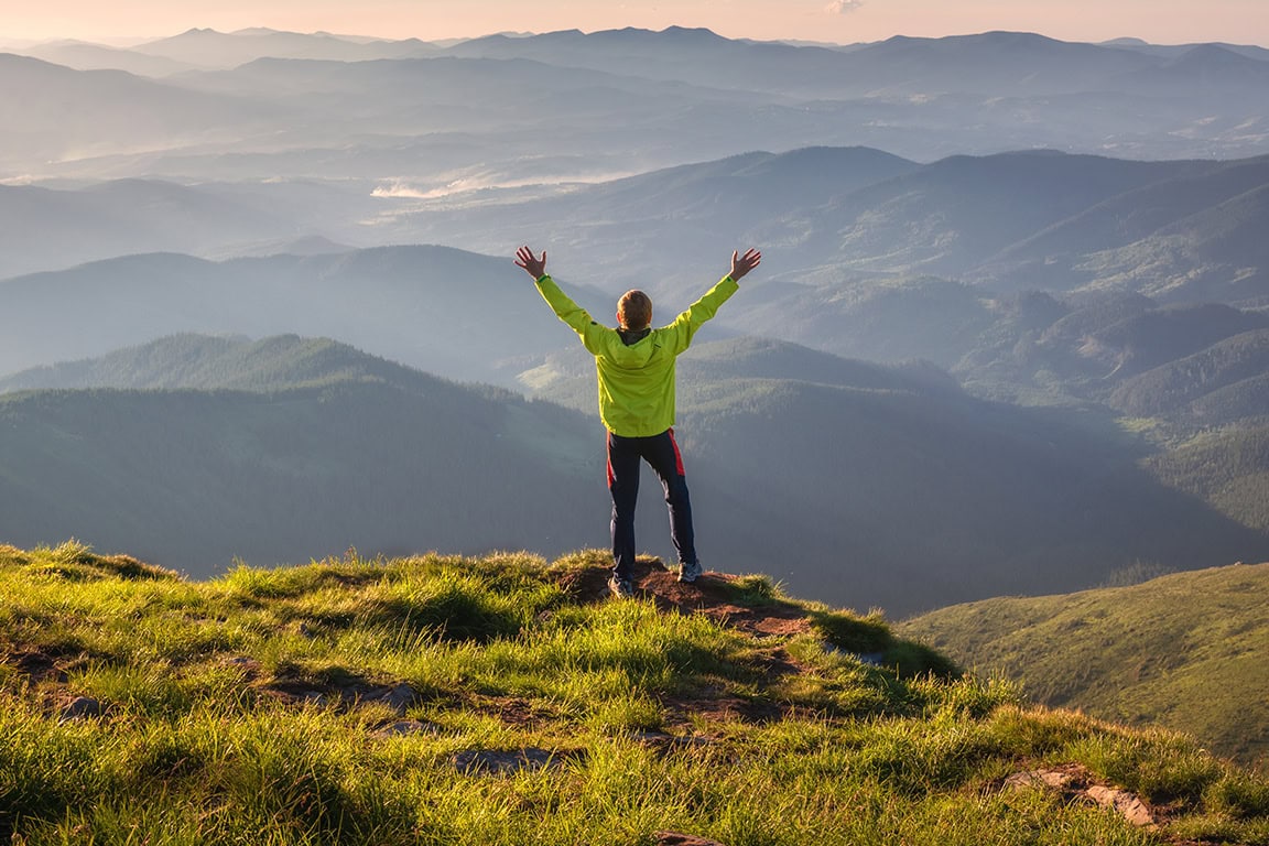 person at the top of a hill