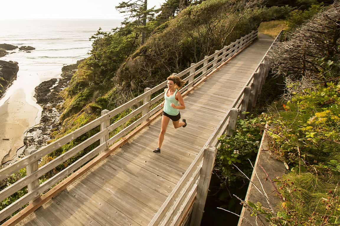 women walking along narrow bridge