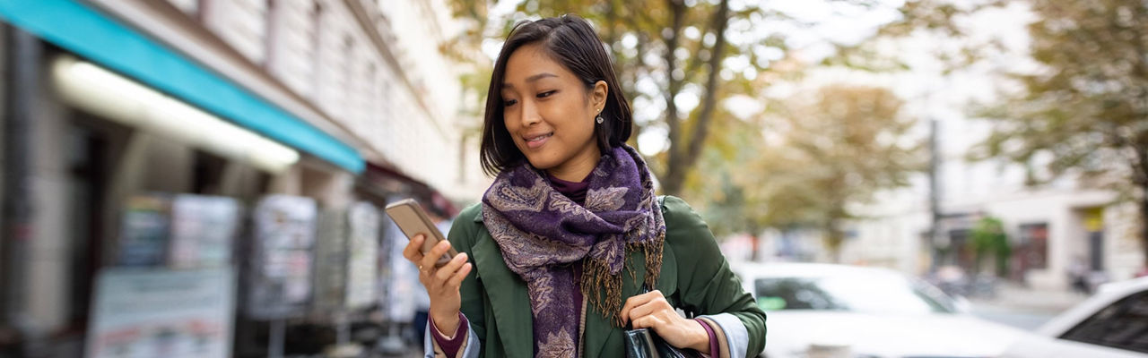 woman sitting while holding Ipad