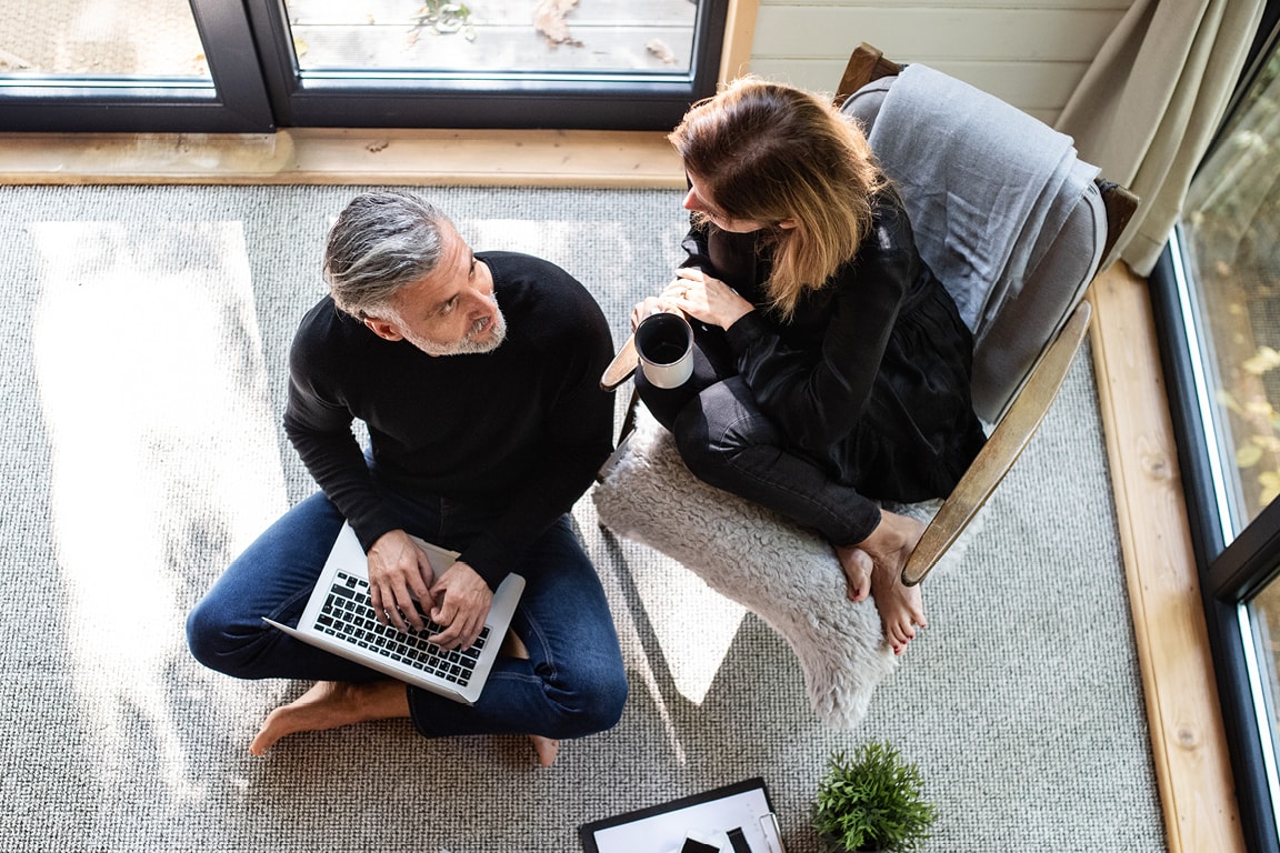 Couple Talking While Sitting In Living 