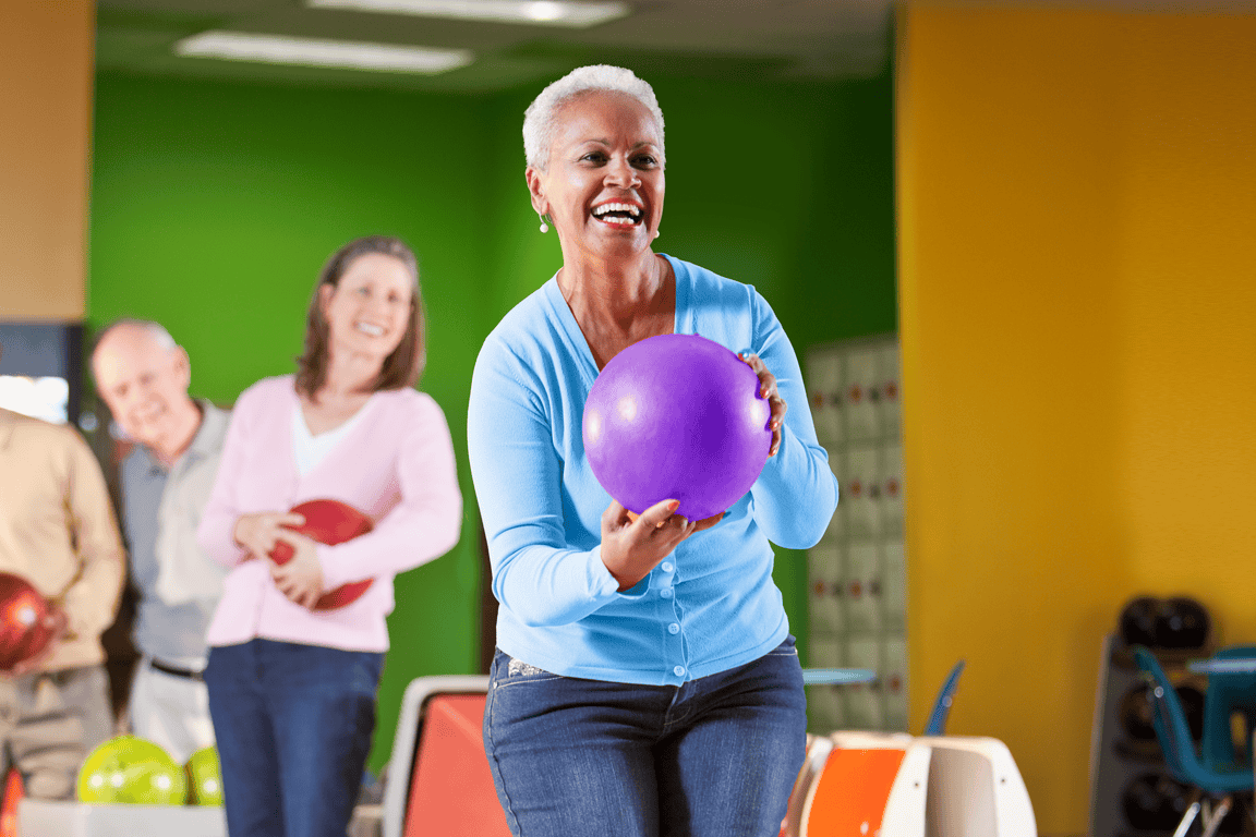 A group of people bowl together
