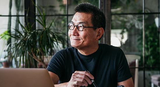 man smiling while looking at window
