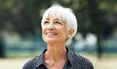 woman smiling while looking at up