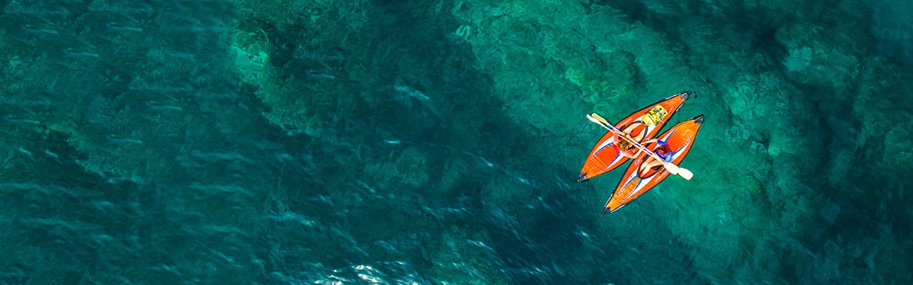 people in kayaks on a lake
